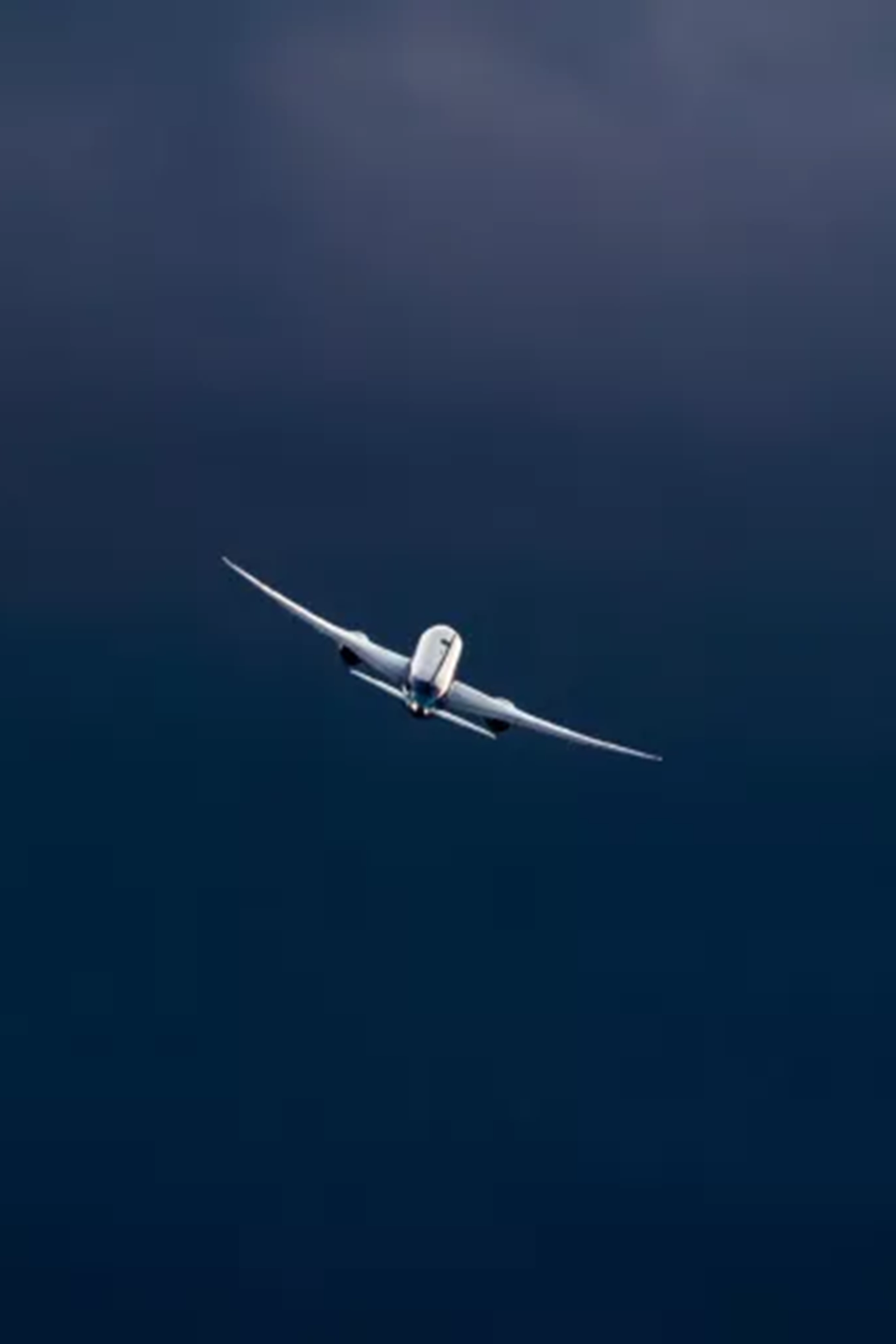 Airplane flying through the blue sky